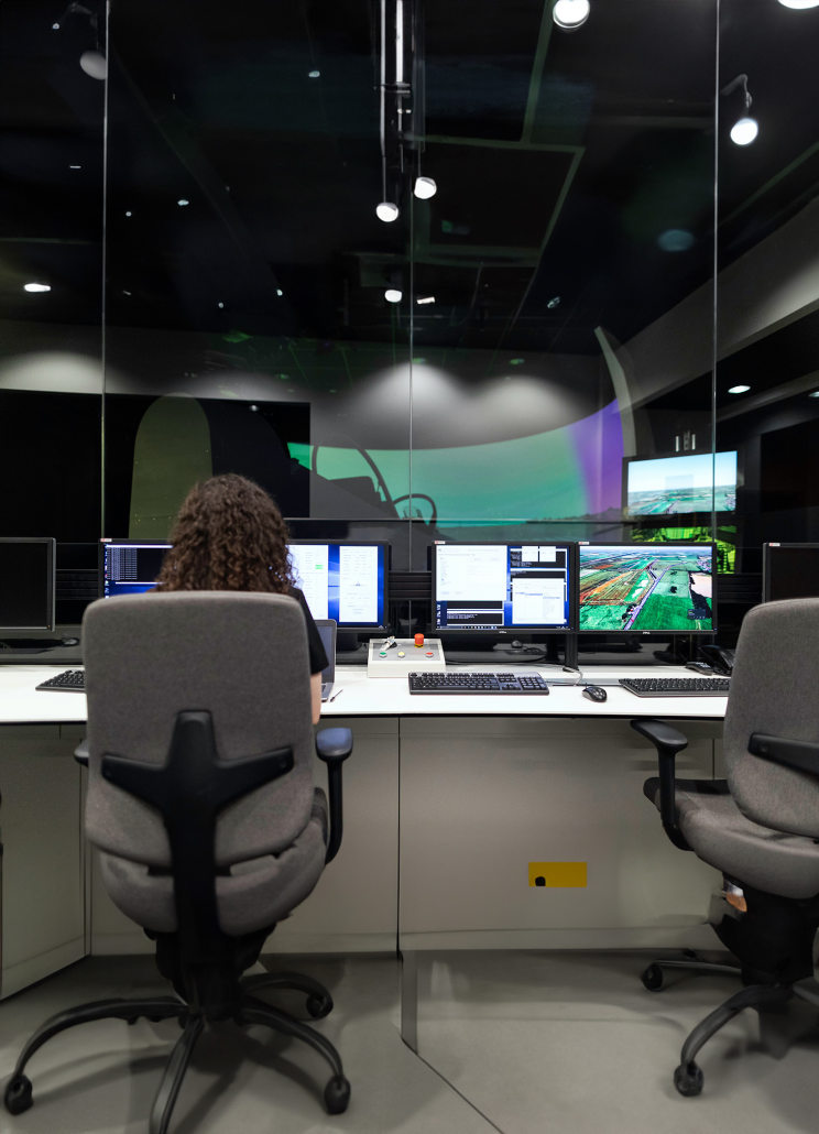 Network & Security Monitoring Services | SurfNet IT & Network Solutions Technician monitoring multiple computer screens in control room for SurfNet network and security services